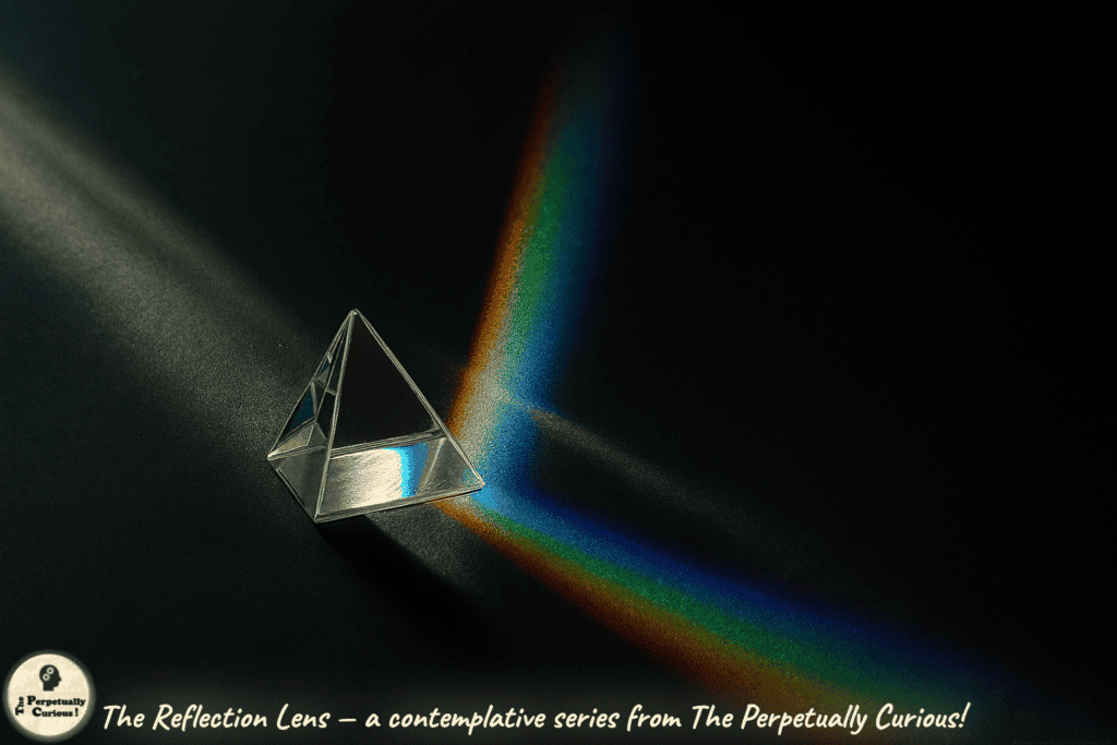 Illustration of a glass prism on a dark surface splitting a narrow beam of light into a vivid rainbow spectrum, with surrounding shadow emphasizing the contrast between light and dark. From The Reflection Lens, a contemplative series from The Perpetually Curious!
